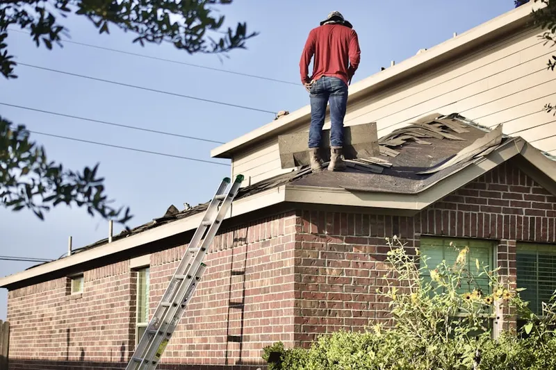 Professional roofer working on a residential roof in Miltonville